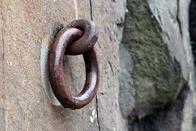 cross tie ring attached to rock face